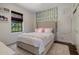 Serene bedroom showcasing a bed with decorative pillows and a natural accent wall at 9904 E South Bend Dr, Scottsdale, AZ 85255
