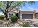 Attractive home with mature landscaping, a two-car garage, and arched windows at 9904 E South Bend Dr, Scottsdale, AZ 85255