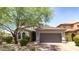 Charming home featuring a two-car garage, arched entry, and professionally maintained desert landscaping at 9904 E South Bend Dr, Scottsdale, AZ 85255