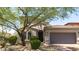 Charming home exterior with desert landscaping, a two-car garage, and arched windows at 9904 E South Bend Dr, Scottsdale, AZ 85255