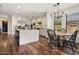 Bright kitchen with island, stainless steel appliances, light cabinetry and a dining table with decorative chandelier at 9904 E South Bend Dr, Scottsdale, AZ 85255