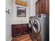 Convenient laundry room with modern washer and dryer, sink, and ample cabinet space at 9904 E South Bend Dr, Scottsdale, AZ 85255