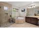 Luxurious primary bathroom with tiled shower, separate soaking tub, vanity and ample counter space at 9904 E South Bend Dr, Scottsdale, AZ 85255