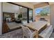 Inviting outdoor patio with barbecue grill, dining area, and seamless transition to indoor living room at 9904 E South Bend Dr, Scottsdale, AZ 85255