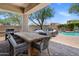 Inviting outdoor patio with dining area, lounge seating, and a refreshing pool at 9904 E South Bend Dr, Scottsdale, AZ 85255