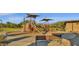 Community playground for children with climbing structure and slide, surrounded by benches at 9904 E South Bend Dr, Scottsdale, AZ 85255