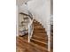 Elegant staircase with wooden steps, metal railing and white banisters, complemented by decorative shelving at 9904 E South Bend Dr, Scottsdale, AZ 85255