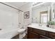 Bathroom with a shower-tub combo, framed mirror, modern vanity, and decorative accents, combining functionality and style at 1029 E Jasper Dr, Gilbert, AZ 85296