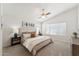 Relaxing bedroom features plush carpeting, a ceiling fan, and ample natural light at 1029 E Jasper Dr, Gilbert, AZ 85296