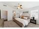 Comfortable main bedroom suite featuring soft carpet, neutral walls, and a decorative ceiling fan at 1029 E Jasper Dr, Gilbert, AZ 85296