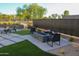 Landscaped backyard featuring a modern fire pit area with lounge seating and decorative rock at 1100 S 176Th Ave, Goodyear, AZ 85338
