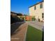 Backyard featuring a bocce ball court, synthetic turf and access to the home at 1100 S 176Th Ave, Goodyear, AZ 85338