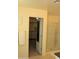 Bathroom doorway view into walk-in closet and glass shower at 1100 S 176Th Ave, Goodyear, AZ 85338