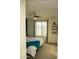 Bedroom featuring a bed with a blue blanket, ceiling fan, and large window at 1100 S 176Th Ave, Goodyear, AZ 85338