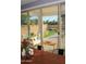 Bright dining area featuring a wood table set, sliding glass door to backyard, and colorful bouquet centerpiece at 1100 S 176Th Ave, Goodyear, AZ 85338