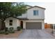 Attractive two-story home with a well-kept front yard, a two-car garage, and a tiled roof at 1100 S 176Th Ave, Goodyear, AZ 85338