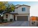 Inviting two-story home featuring a well-maintained front yard and a two-car garage at 1100 S 176Th Ave, Goodyear, AZ 85338