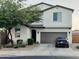 Charming two-story home boasts a well-manicured front yard and an attached two-car garage at 1100 S 176Th Ave, Goodyear, AZ 85338
