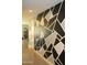 Hallway with modern geometric wall design, showcasing a clean and contemporary aesthetic at 1100 S 176Th Ave, Goodyear, AZ 85338