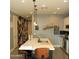 Kitchen island with barstool seating, stainless steel sink, and modern pendant lighting at 1100 S 176Th Ave, Goodyear, AZ 85338
