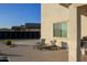 Back patio featuring comfortable lounge chairs with a view of neighboring rooftops and solar panels at 1100 S 176Th Ave, Goodyear, AZ 85338