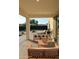 Covered patio featuring comfortable seating area with a grill, overlooking pool and solar panels at 1100 S 176Th Ave, Goodyear, AZ 85338