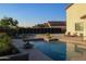 Inviting backyard oasis featuring a sparkling pool, sun loungers and lush landscaping at 1100 S 176Th Ave, Goodyear, AZ 85338