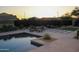 Backyard featuring a luxurious pool, lounge chairs, a fire pit, and tasteful landscaping at 1100 S 176Th Ave, Goodyear, AZ 85338