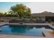 Beautiful pool with elegant water feature, lush greenery, and spacious patio area at 1100 S 176Th Ave, Goodyear, AZ 85338