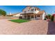 Home exterior shows a spacious backyard with rock, patio, lawn, and covered balcony at 1202 E Libby St, Phoenix, AZ 85022