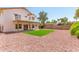 Spacious backyard featuring a well-maintained green lawn, a patio, and a balcony with views at 1202 E Libby St, Phoenix, AZ 85022