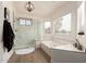 Bathroom boasting a glass enclosed shower, soaking tub, and white marble style accents at 1202 E Libby St, Phoenix, AZ 85022
