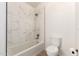 Bright bathroom features a tiled shower and tub combo, along with a toilet and new fixtures at 1202 E Libby St, Phoenix, AZ 85022