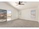 A well-lit bedroom with a sliding door, carpeted floors, and multiple windows at 1202 E Libby St, Phoenix, AZ 85022