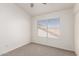 Bedroom featuring carpeted floors and a large window with horizontal blinds at 1202 E Libby St, Phoenix, AZ 85022