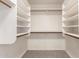 Walk-in closet offering built-in shelving and wood rods for optimal storage space at 1202 E Libby St, Phoenix, AZ 85022
