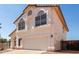 Two-story home featuring a terra cotta-colored roof, white stucco, arched windows, and a two-car garage at 1202 E Libby St, Phoenix, AZ 85022