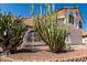 Landscaped front yard featuring desert vegetation, including cacti, rock mulch, and low brick wall at 1202 E Libby St, Phoenix, AZ 85022