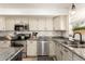 Bright kitchen with stainless steel appliances, granite countertops, and ample cabinet space at 1202 E Libby St, Phoenix, AZ 85022