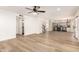 Spacious living room with modern light wood floors, and views to the kitchen and staircase at 1202 E Libby St, Phoenix, AZ 85022