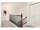 Carpeted staircase with a dark wood railing, leading to the upper level of the home at 1202 E Libby St, Phoenix, AZ 85022