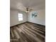Cozy bedroom with fresh paint, ceiling fan, laminate flooring, and lots of natural light from two windows at 1214 E Henry St, Tempe, AZ 85288