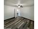 Bright bedroom features laminate flooring, fresh paint, and a view into the kitchen at 1214 E Henry St, Tempe, AZ 85288
