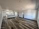 Open-concept living room and kitchen boasts modern laminate flooring and abundant natural light at 1214 E Henry St, Tempe, AZ 85288