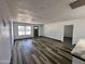 Open-concept living room boasts new flooring, fresh paint, and ample natural light from the large front window at 1214 E Henry St, Tempe, AZ 85288