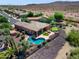 Aerial view displays a house with a pool, spa, putting green, outdoor seating, and desert landscaping at 13072 W Alyssa Ln, Peoria, AZ 85383