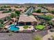 Aerial view of a home featuring a private pool, putting green, and covered patio area at 13072 W Alyssa Ln, Peoria, AZ 85383
