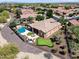 Aerial view displaying a pool, spa, putting green, backyard, desert landscaping, and covered outdoor kitchen at 13072 W Alyssa Ln, Peoria, AZ 85383