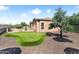 Backyard with putting green, desert landscaping, and built in BBQ and jacuzzi at 13072 W Alyssa Ln, Peoria, AZ 85383
