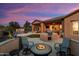 Inviting backyard features a built-in grill, fire pit, covered patio, and a beautiful pool with manicured landscaping at 13072 W Alyssa Ln, Peoria, AZ 85383